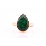 A single stone emerald single stone ring, the faceted pear-shaped emerald in rub-over mount to a