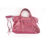 A Balenciaga pink leather handbag with zipped pockets and opening, the tag numbered No 1756 T,
