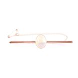 A 15ct yellow gold and opal bar brooch, set with an oval cabochon clear opal, showing good blue