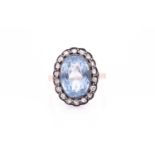 A diamond and blue stone cocktail ring, set with a mixed oval-cut gemstone (possibly spinel),