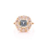 An 18ct yellow gold, diamond, and aquamarine cluster ring, set with a cushion-cut aquamarine of