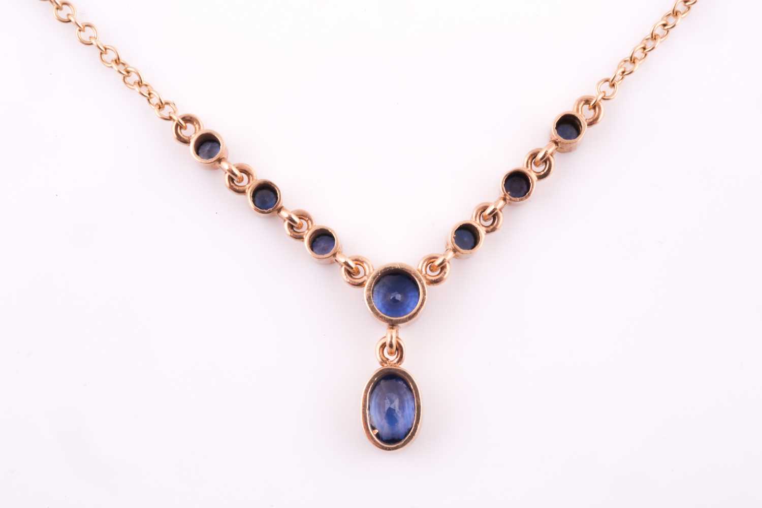 A 9ct yellow gold and blue sapphire drop pendant necklace, set with a mixed oval-cut sapphire - Image 2 of 4