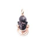 A yellow metal and enamel Blackamoor pendant, the figure with gold wire necklace, and two earrings