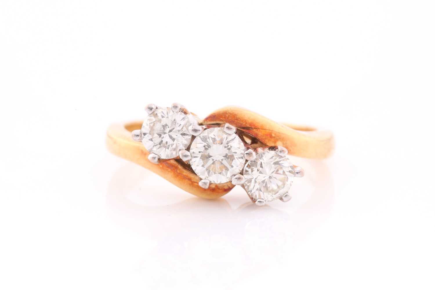 An 18ct yellow gold and diamond crossover ring, set with three round brilliant-cut diamonds of