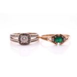 An emerald and diamond three stone half hoop ring. the oval cut emerald, horizontally set with