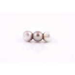 A pearl and diamond ring, set with three natural saltwater pearls, white, pale, and darker grey, the