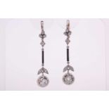 A pair of Art Deco diamond drop earrings, each set with a round-cut diamond of approximately 1.60