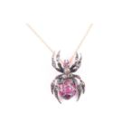 A silver gilt, diamond, and ruby spider pendant, the spider's body inset with mixed-cut rubies,