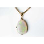 A yellow metal mounted opal pendant, the Australian white opal with strong green play of colour,