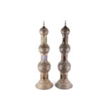 A pair of Middle eastern floor-standing Mosque lamps, converted to electricity, with pierced brass