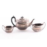 A late Victorian three-piece silver teaset, Sheffield 1892 by Walker and Hall, comprising teapot,