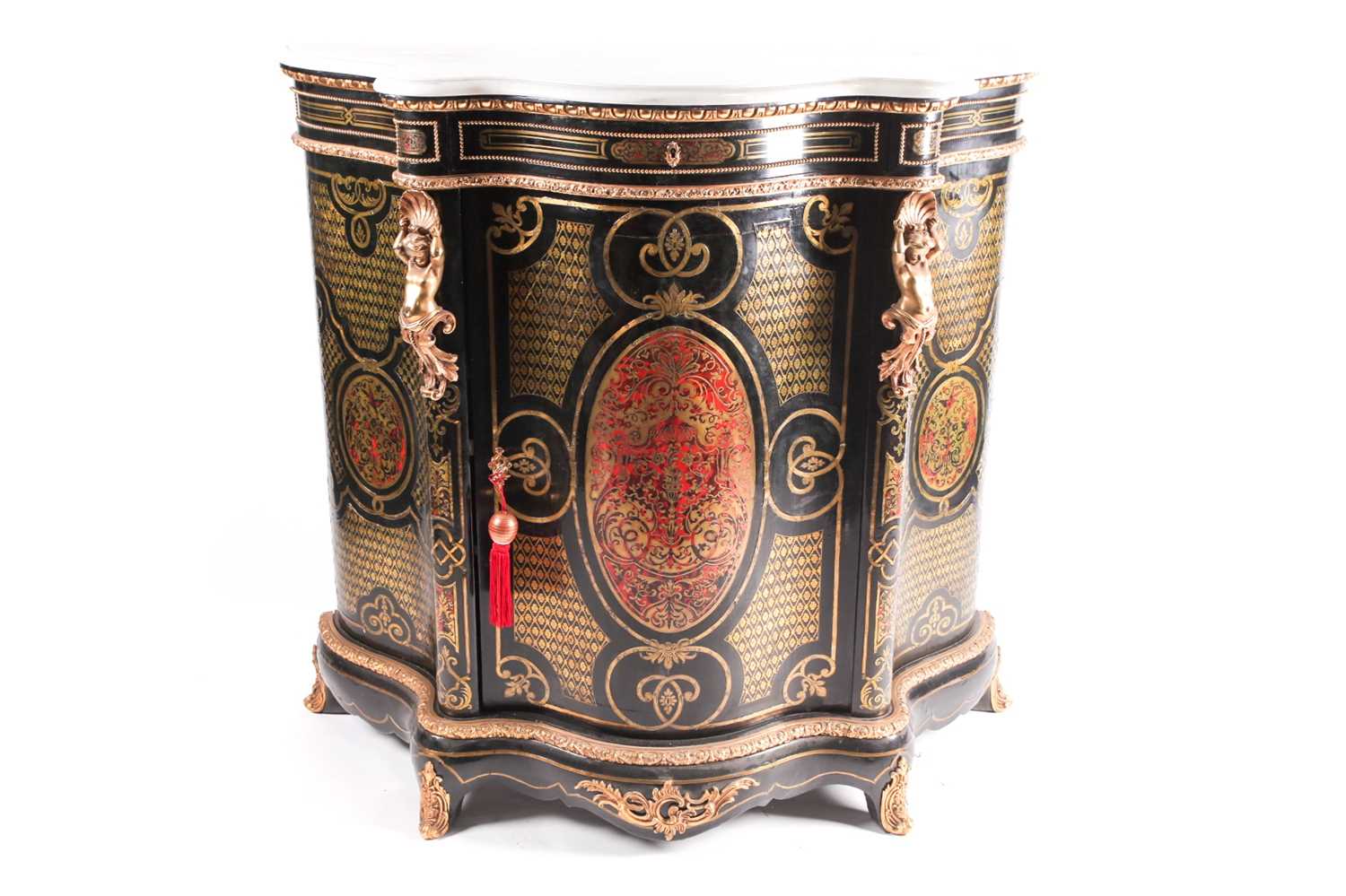 A 19th century French ebonized and red Boulle inlaid serpentine single door credenza, with shaped