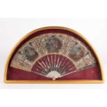 A gilt-framed late 18th century carved and pierced ivory fan with gilt and oxidised silver