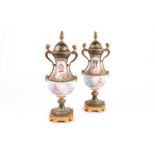 A pair of Chateau de Tuileries Sevres porcelain and ormolu two-handled urn-shaped vases and