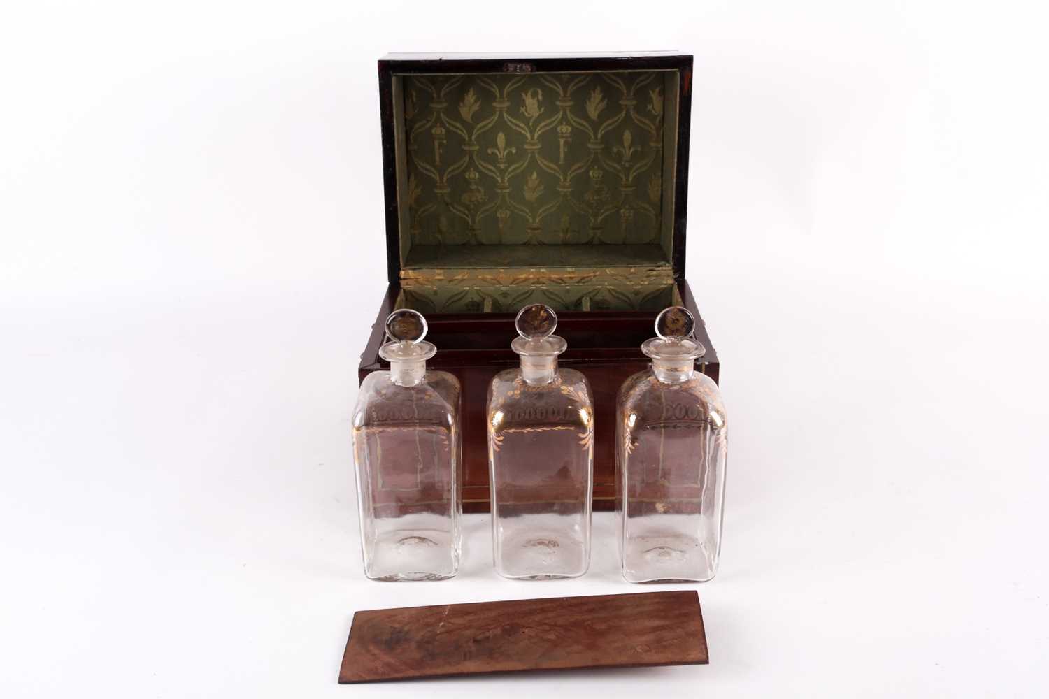 A Regency mahogany and brass bound three-bottle decanter set, the silk-lined interior with bottle - Image 3 of 5