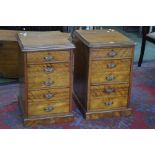 A pair of satinwood bedside chests of three graduated drawers, the second and third drawers with
