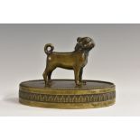 A 19th century French dark patinated bronze desk weight, as a pug, oval base with anthemion