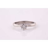 A single stone diamond ring, the round brilliant cut diamond eight claw set to a platinum mount with