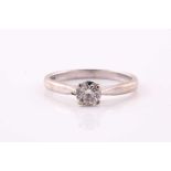 A single stone diamond ring; the round brilliant cut diamond in four claw mount to plain platinum