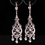 A pair of diamond drop earrings, set with a collet-set old-cut diamond measuring approximately 0.