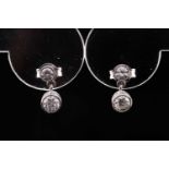 A pair of 18ct white gold and diamond drop earrings, each with a larger and smaller collet-set
