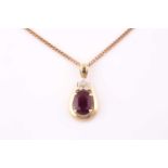 A ruby and diamond pendant, the pinkish-red opaque ruby measuring 12.8 x 10.5 x 3.6mm approximately,