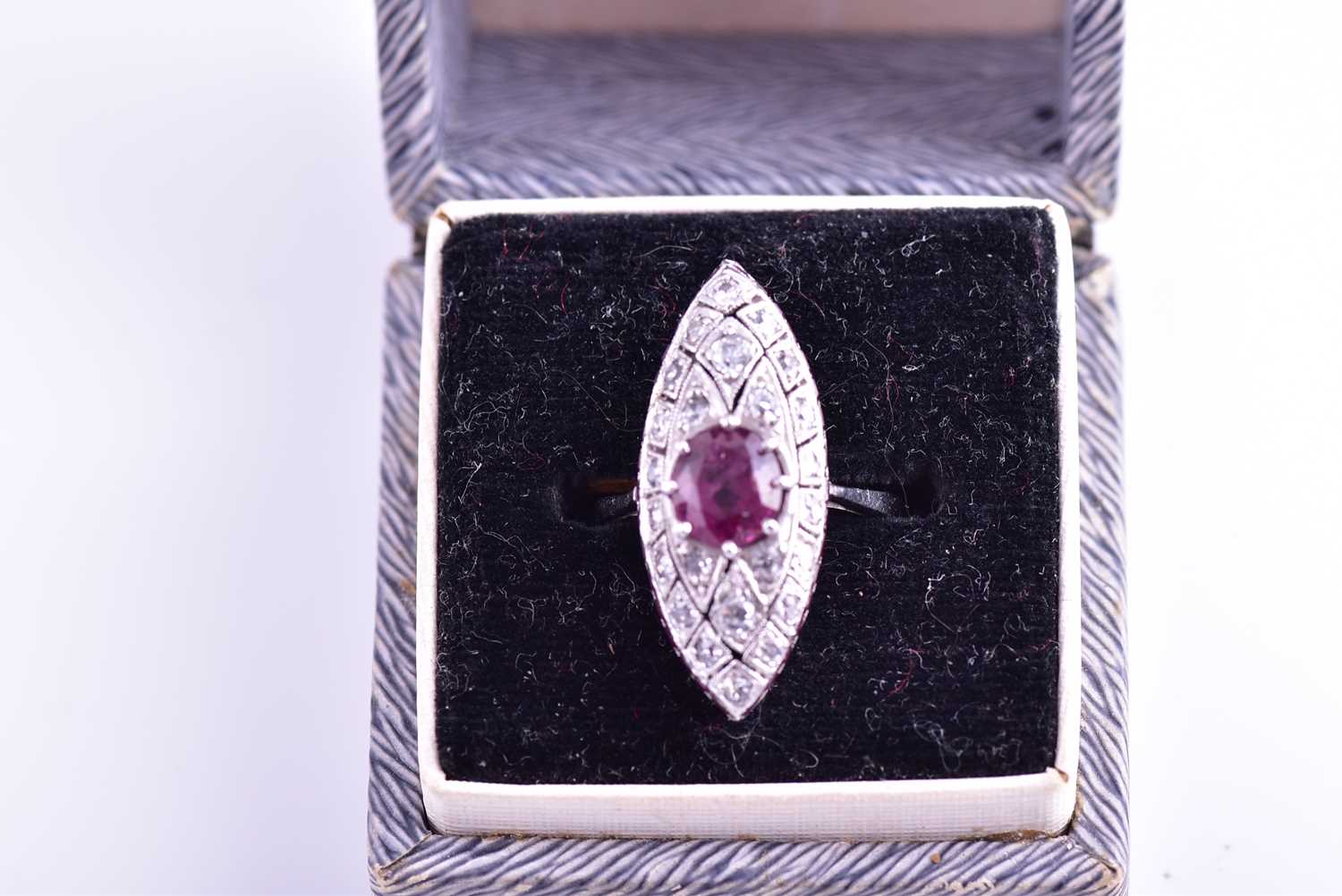 An 18ct white gold, diamond, and ruby ring, the marquise-shaped mount inset with a mixed round-cut