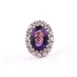 An 18ct yellow gold, diamond, and amethyst cluster ring, set with a mixed oval-cut amethyst,