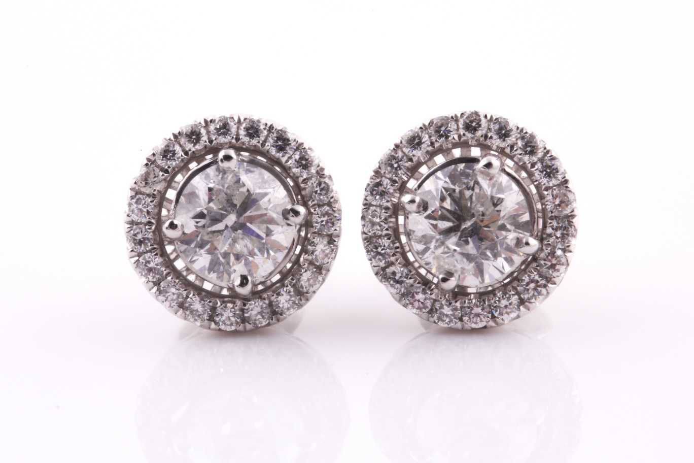 A pair of diamond halo cluster earrings, centred with round brilliant-cuts of approximately 1.40