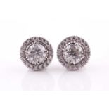 A pair of diamond halo cluster earrings, centred with round brilliant-cuts of approximately 1.40