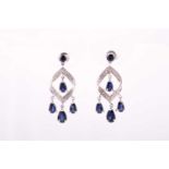 A pair of 9ct white gold diamond, and sapphire drop earrings, the pave-set diamond mount suspended