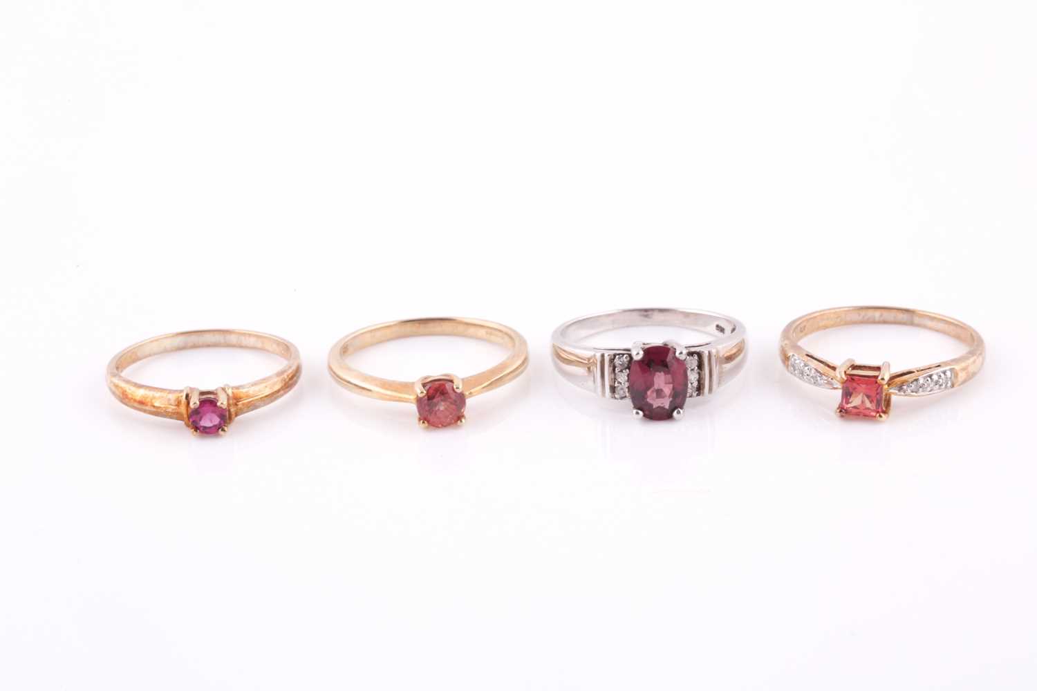 A 9ct yellow gold and pink sapphire ring, size N, together with two 9ct yellow gold and orange