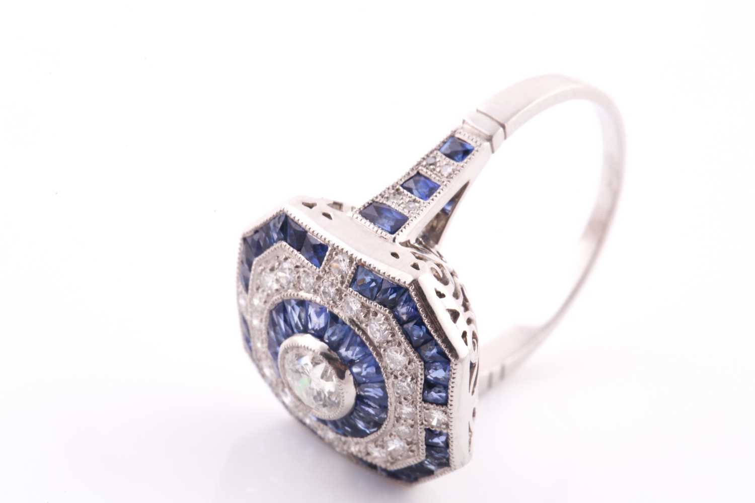 A platinum, diamond, and sapphire cluster ring, centred with a round-cut diamond within a - Bild 6 aus 6