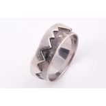 An unusual 9ct white gold ring, the jagged mount inset with three diamond accents, size R 1/2, 7.5