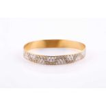 A 22ct yellow gold bangle, with honeycomb effect decoration, marked 'Aufenia' and '22ct' to