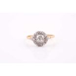 A yellow metal and diamond cluster ring, set with an old-cut diamond of approximately 0.80 carats,