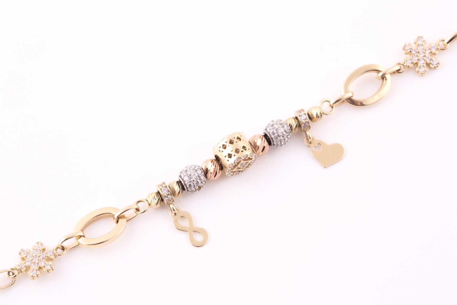 A charm bracelet; the oval link chain strung and suspended with various charms and beads, some set