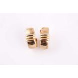 A pair of Cartier 18 carat gold "Colomba" two-tone earrings with post and clip fitting, marked