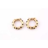 A pair of Kutchinsky 18 carat gold and enamel leopard spot hoop earrings; the tapering, textured