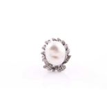 A diamond and pearl cocktail ring, set with a South Sea baroque pearl measuring approximately 18.7 x