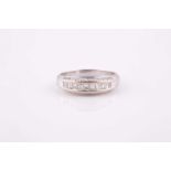 An 18ct white gold and diamond ring, the mount channel-set with a central line of princess- and