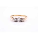 An 18ct yellow gold and diamond ring, set with three old round-cut diamonds, the central stone