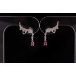 A pair of ruby and diamond earrings; styled as diamond set foliate scrolls, set with round brilliant