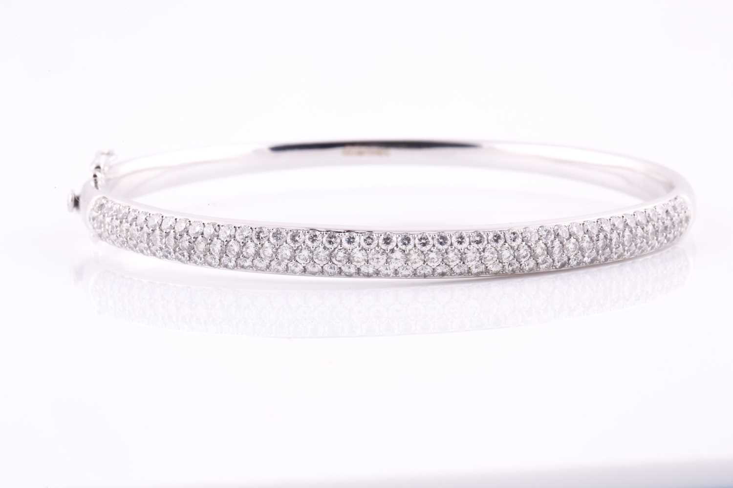 A diamond set hinged bangle, pavé set with one hundred and twenty seven round brilliant cut diamonds