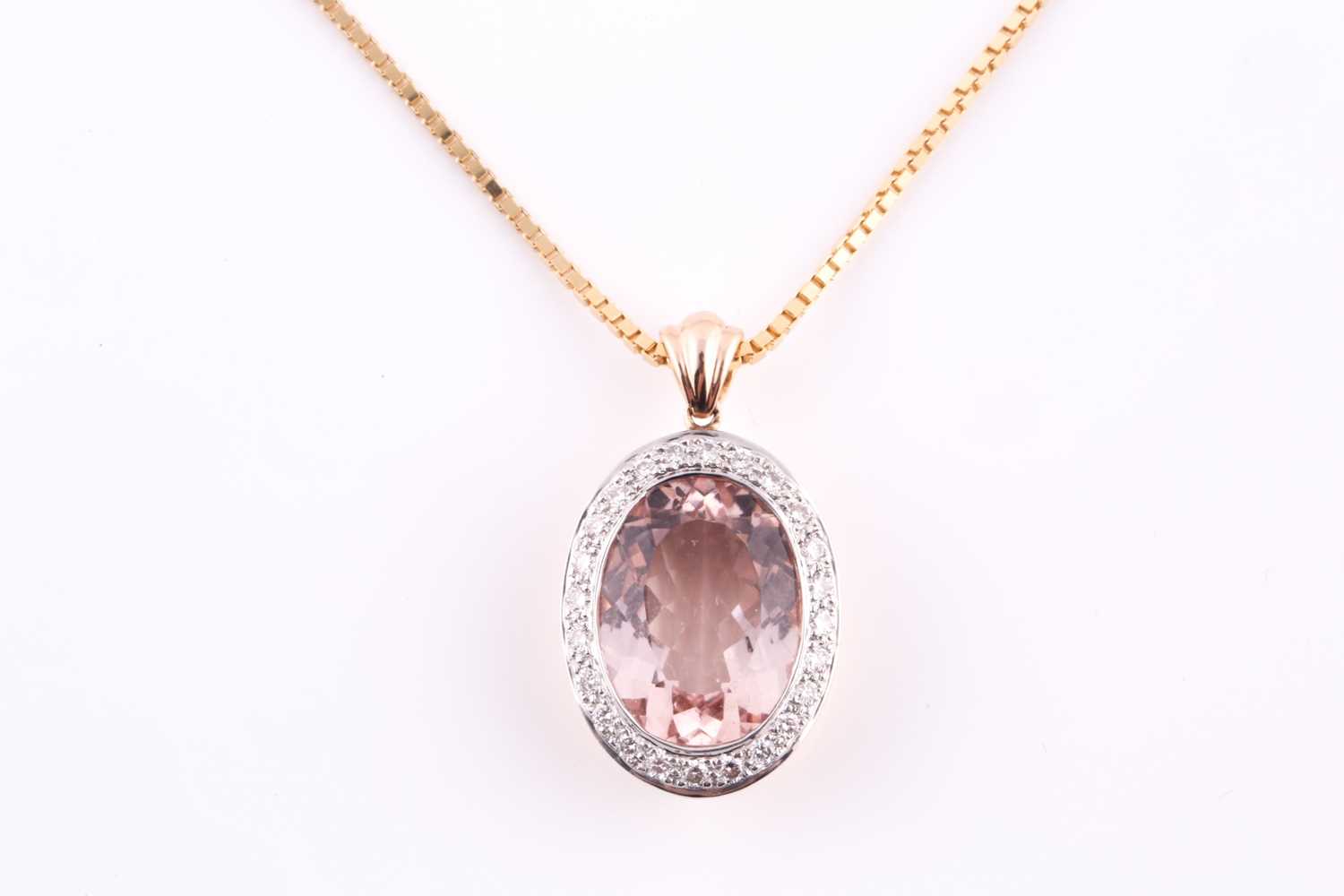 A morganite and diamond pendant, morganite 13.5 x 10 x 5.2mm, within a surround of twenty four round