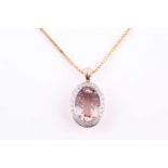 A morganite and diamond pendant, morganite 13.5 x 10 x 5.2mm, within a surround of twenty four round