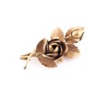An 18ct yellow gold floral spray brooch, in the form of a rose and bud amongst leaves, marked to