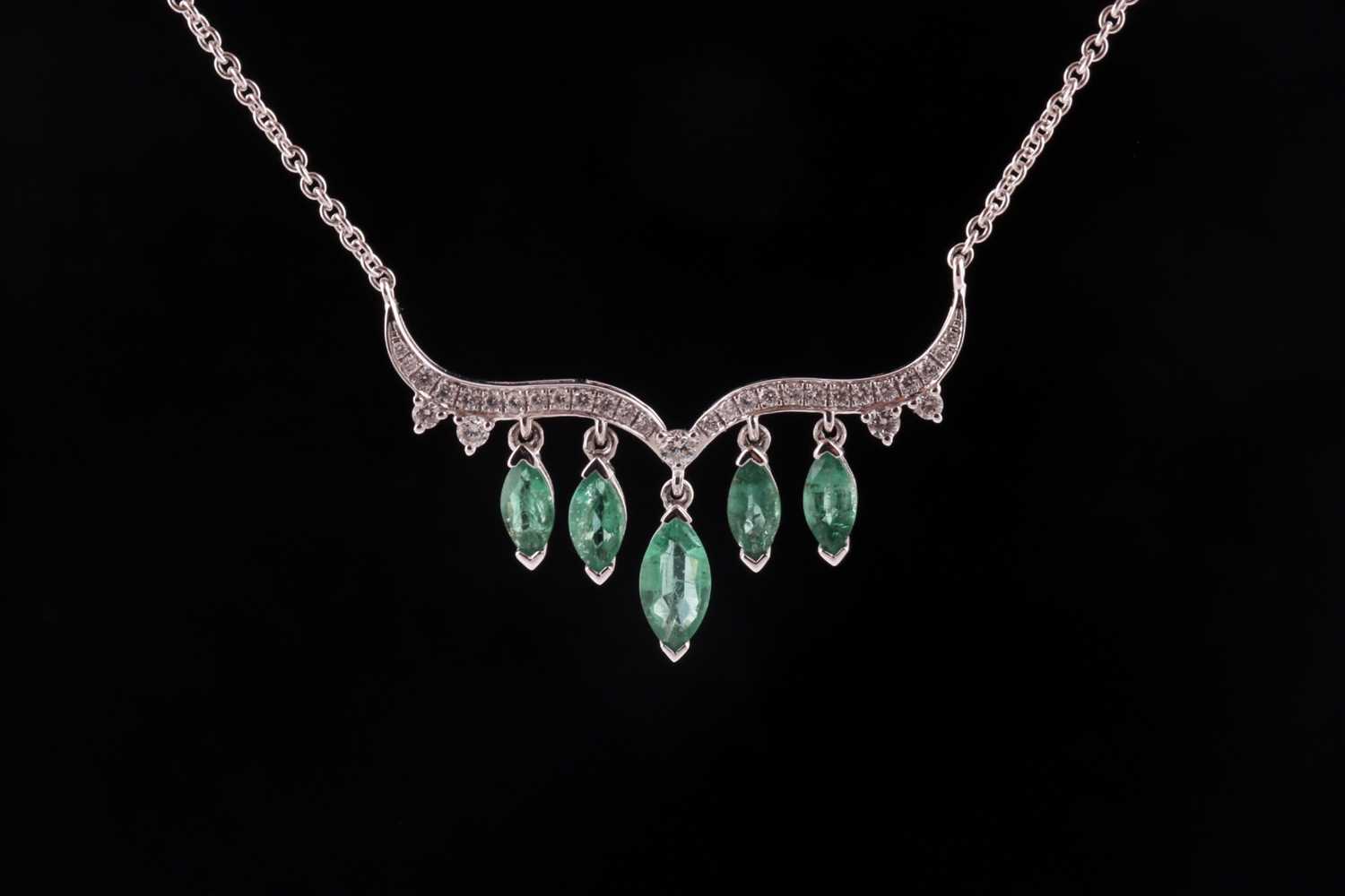 An emerald and diamond necklace; the scroll-shaped diamond set centre suspending five graduated