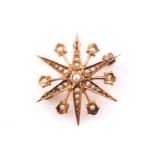 A 15ct yellow gold and split seed pearl starburst brooch / pendant, with pin fitting and suspenson