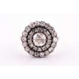 A diamond cluster ring, set with an old mine-cut diamond, measuring approximately 6 mm diameter,
